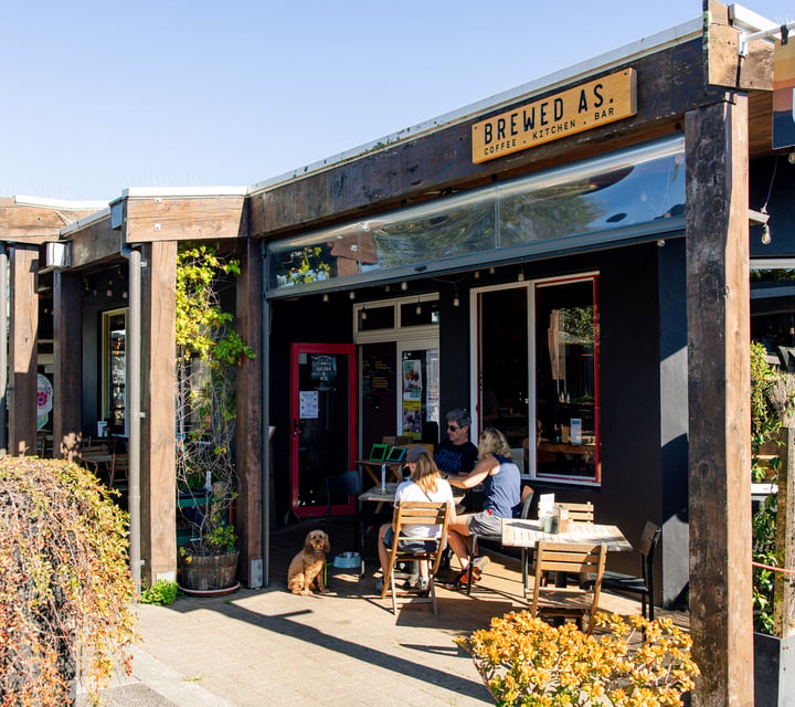 Table of diners outside Brewed As.