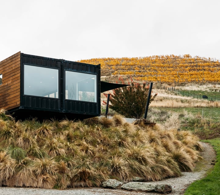 Exterior of Dicey's tasting room set against an autumnal Central Otago landscape.