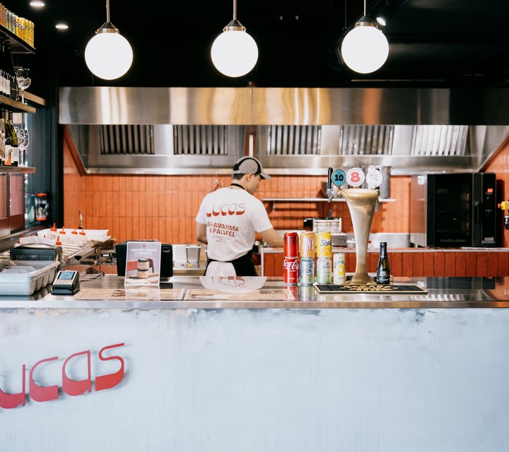 Worker standing behind counter of Lucas at Little High Eatery in Christchurch