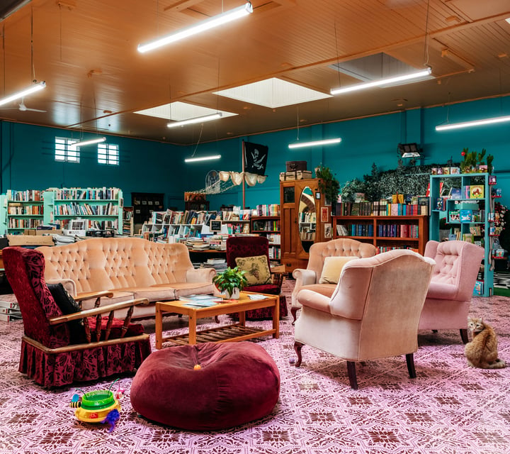 Sofa area with bookshelves behind in Mewington's Book Shoppe.