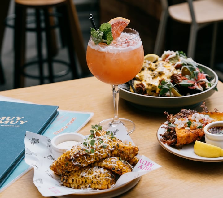Tacos, corn, nachos and cocktail on table at Muy Muy in Christchurch