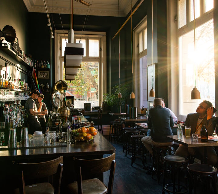 Sunlight streaming through OGB's speakeasy-style bar in Christchurch