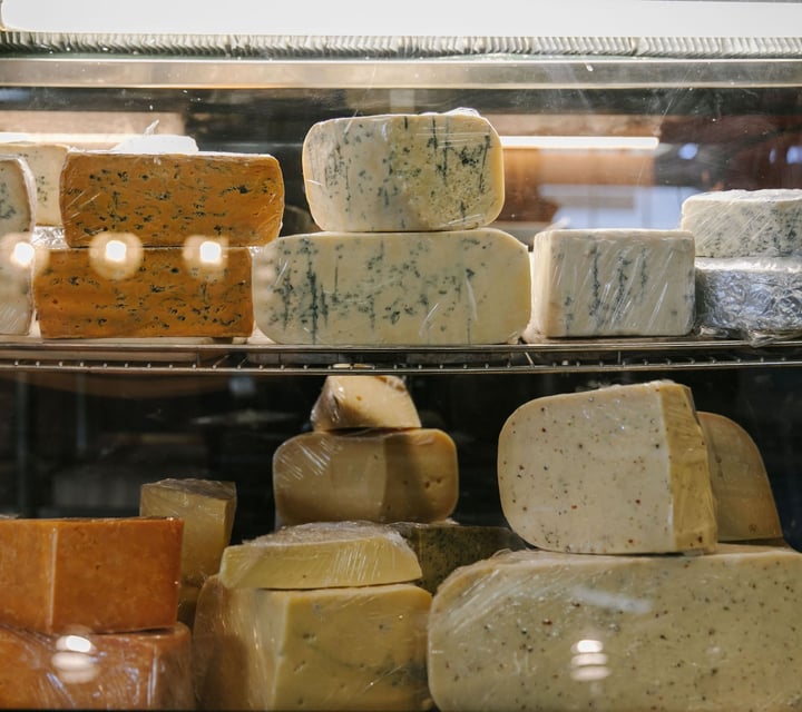 Cheeses on display in fridge at Old Factory Corner, Nelson Tasman.