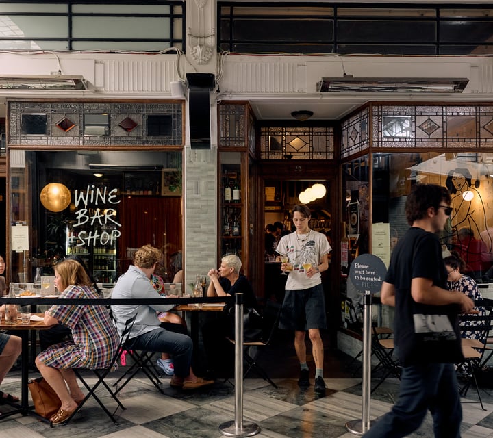 Entrance of Pici Pasta in Auckland with people dining outside in the arcade