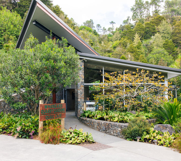 Exterior of Quail Cafe surrounded by lush gardens.