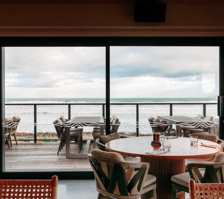 A view of the beach from inside Tahu restaurant Gisborne.