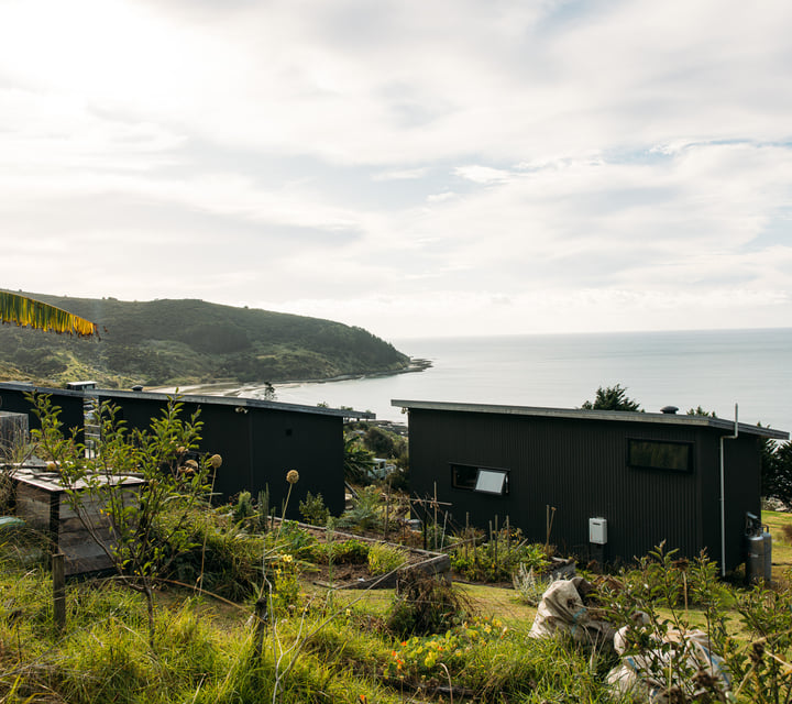 The Huts accommodation and view to the ocean.