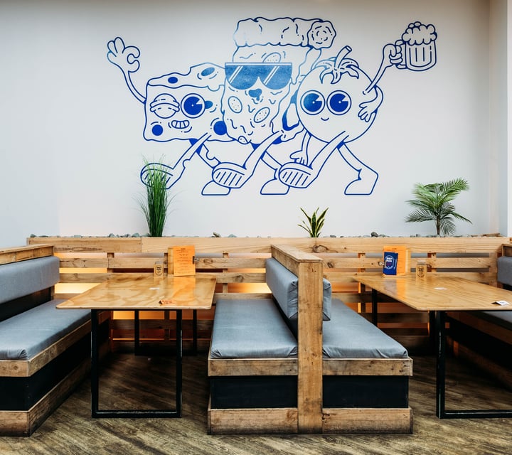 A blue illustration on a wall inside Tony's Pizza in Palmerston North.