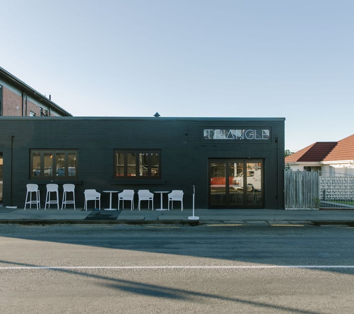 The painted black brick exterior of Triangle Espresso in Ashburton.