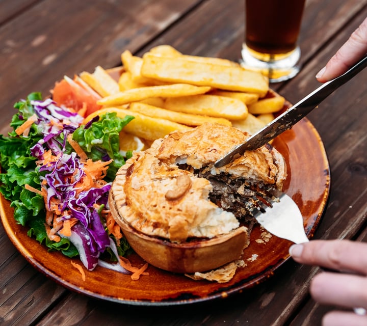 A close up of a pie being cut into.