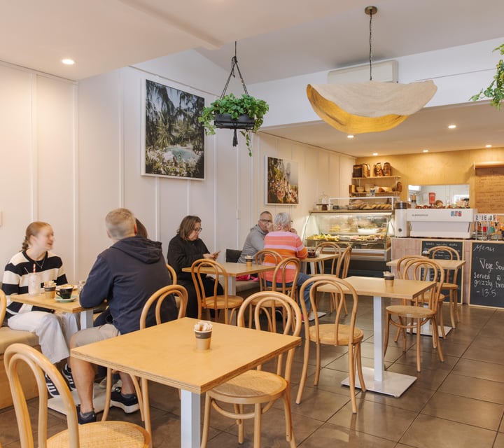 Busy cafe interior with customers at tables in Woods Cafe.