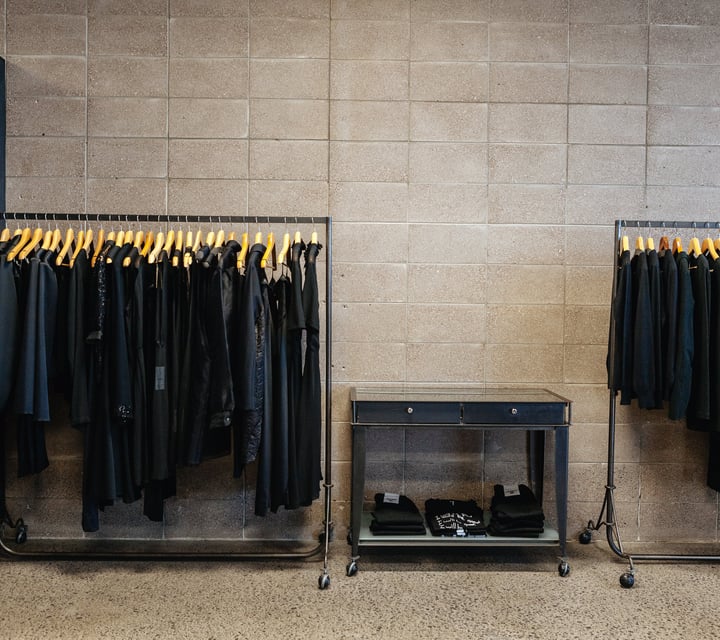 Black clothes on racks.