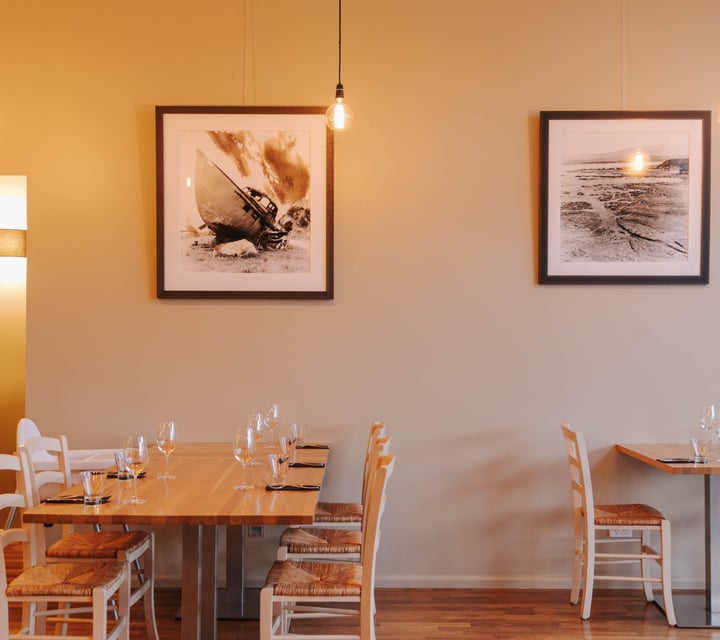 Table set at Zephyr with artwork hanging above.