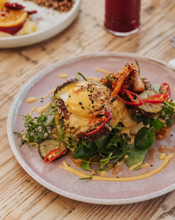 A plate of brunch on a table at Buster Greens.