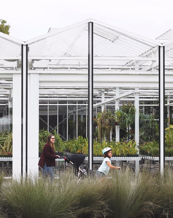 Woman with two children walking through the botanical gardens in Christchurch.