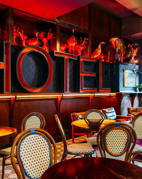 A massive red 'HOTEL' sign on a wall.