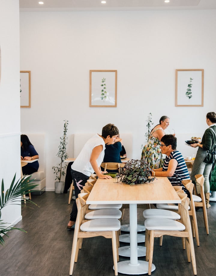 People dining around a table at The Origin, Christchurch.