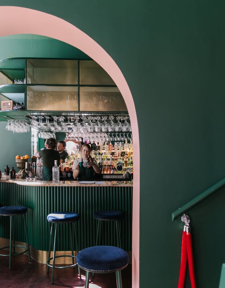 Interior view of gin gin feature green and pink contrast archway.