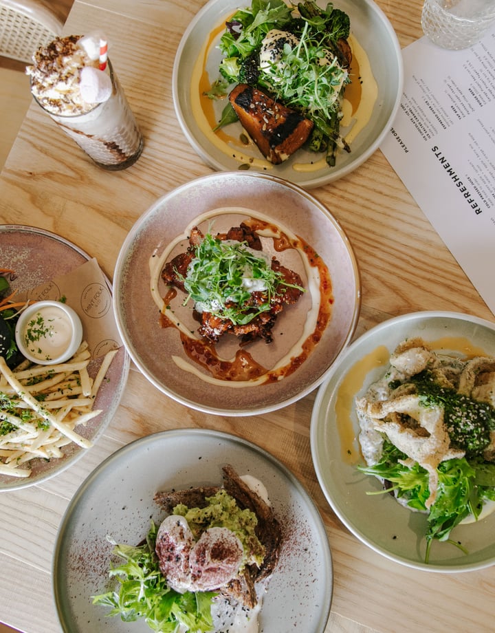 A flatlay of plates of food on a table at Mint Folk in Twizel.