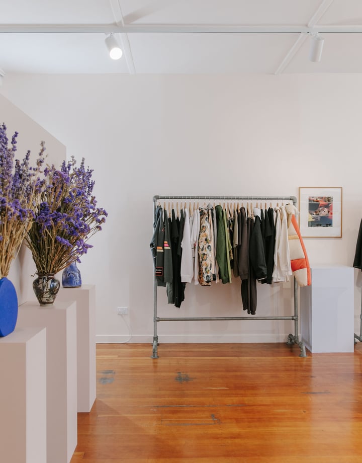 Clothing on display on racks inside Company Store Dunedin.