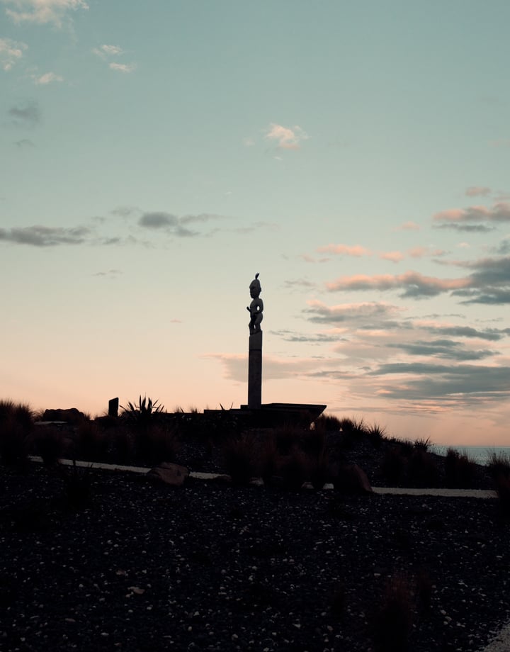 A view of a tall sculpture in Kaikoura at sunset.