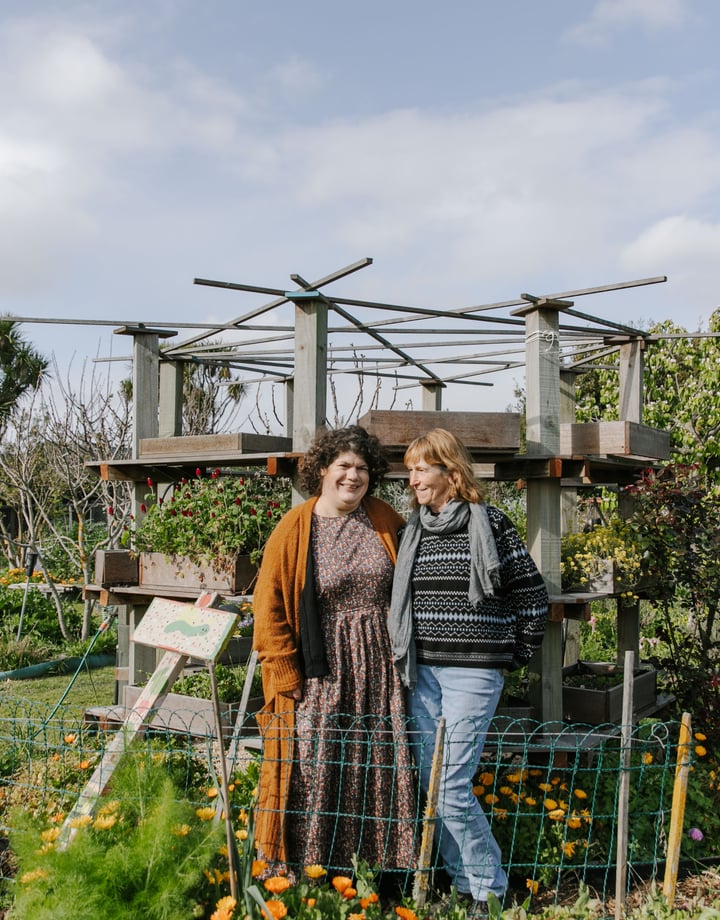 Catherine O’Neill and Lin Klenner smiling in their New Brighton Community Gardens.