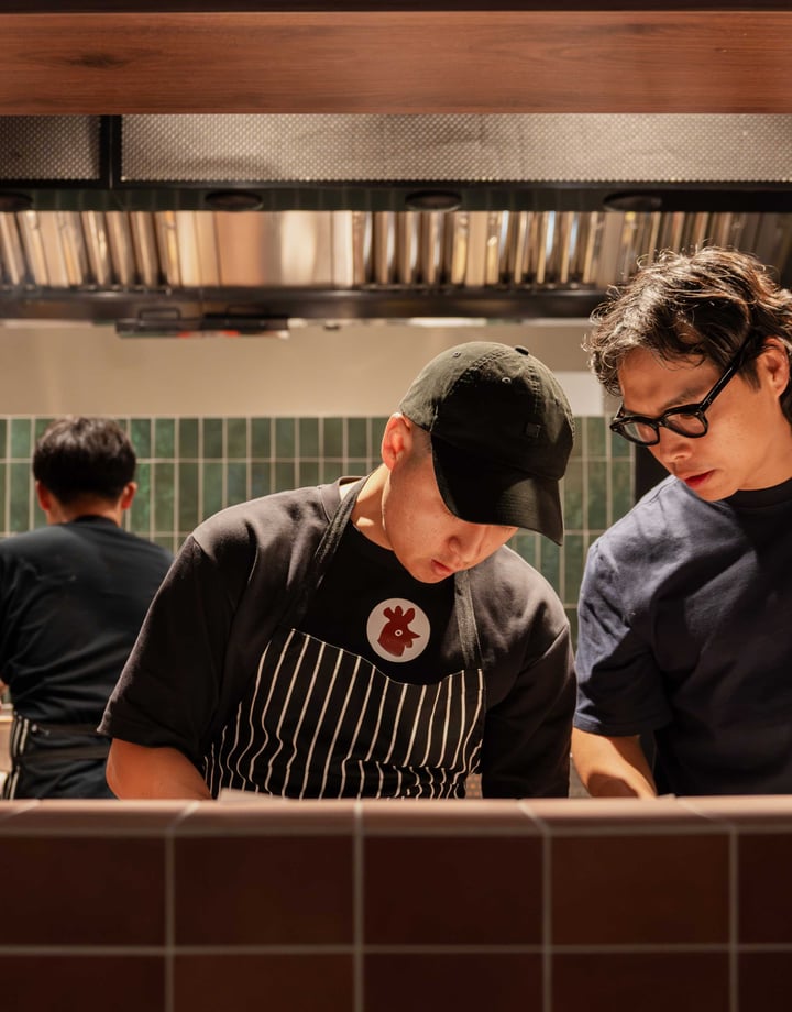 Two men working in a hot looking kitchen.