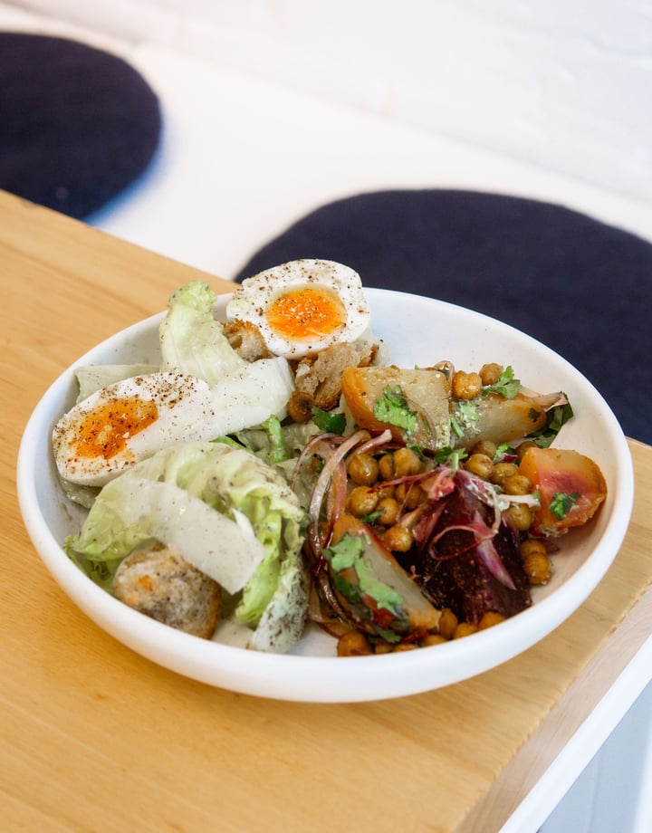 Bowl of fresh salad with a boiled egg on the table at Estelle Cafe in Christchurch