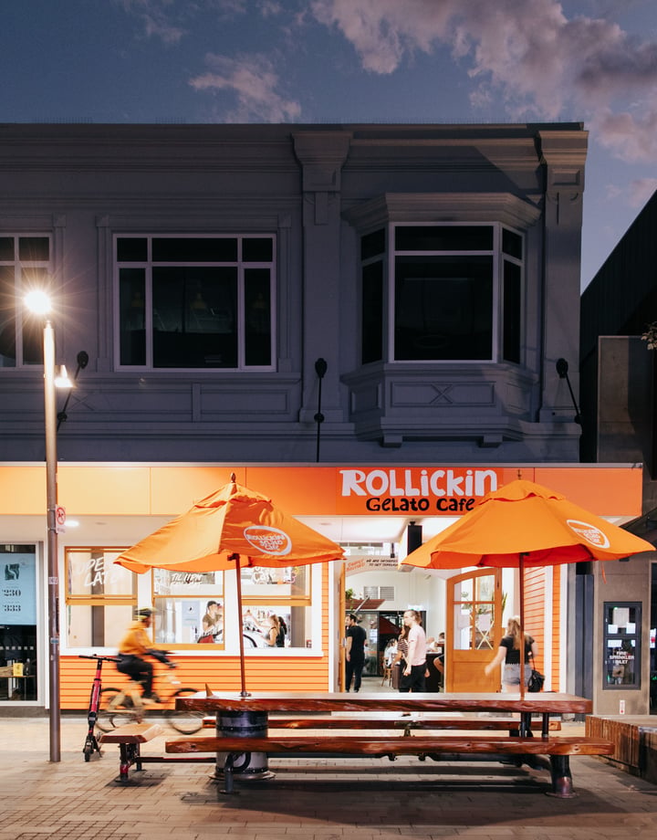 An orange cafe at night time.