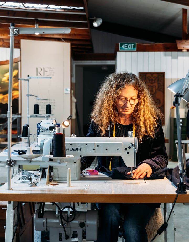 A woman working at a sewing machine.