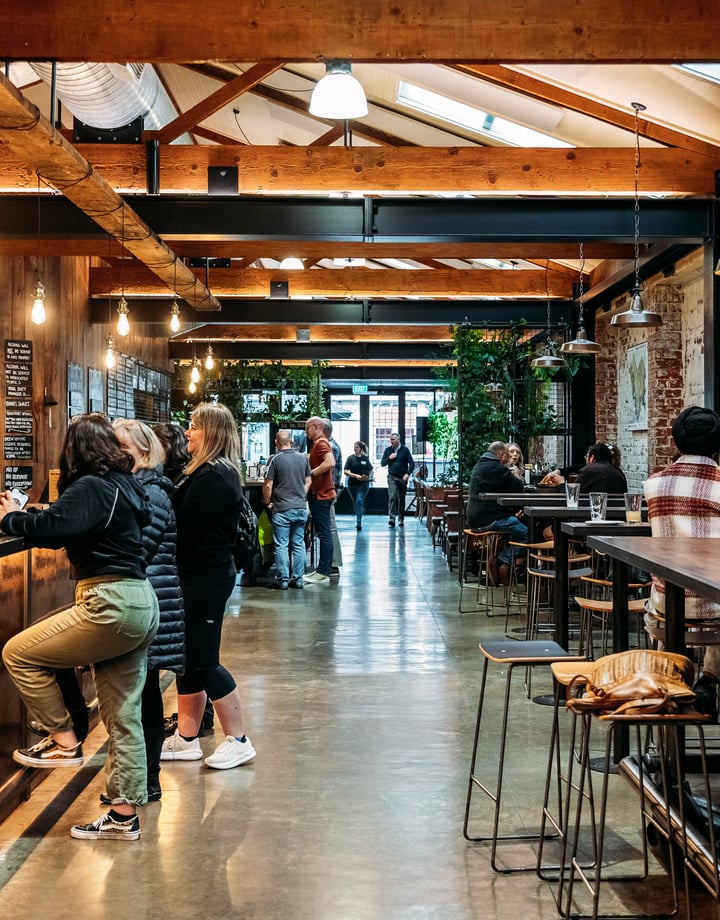 Customers at the bar at Brew Union.