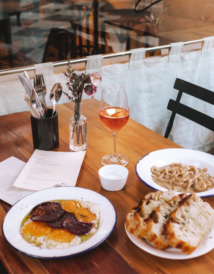 Pasta and bread on a table at Pick in Auckland.