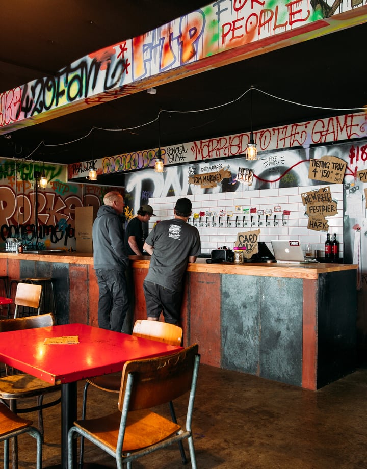 Two customers ordering beers at Abandoned Brewery.