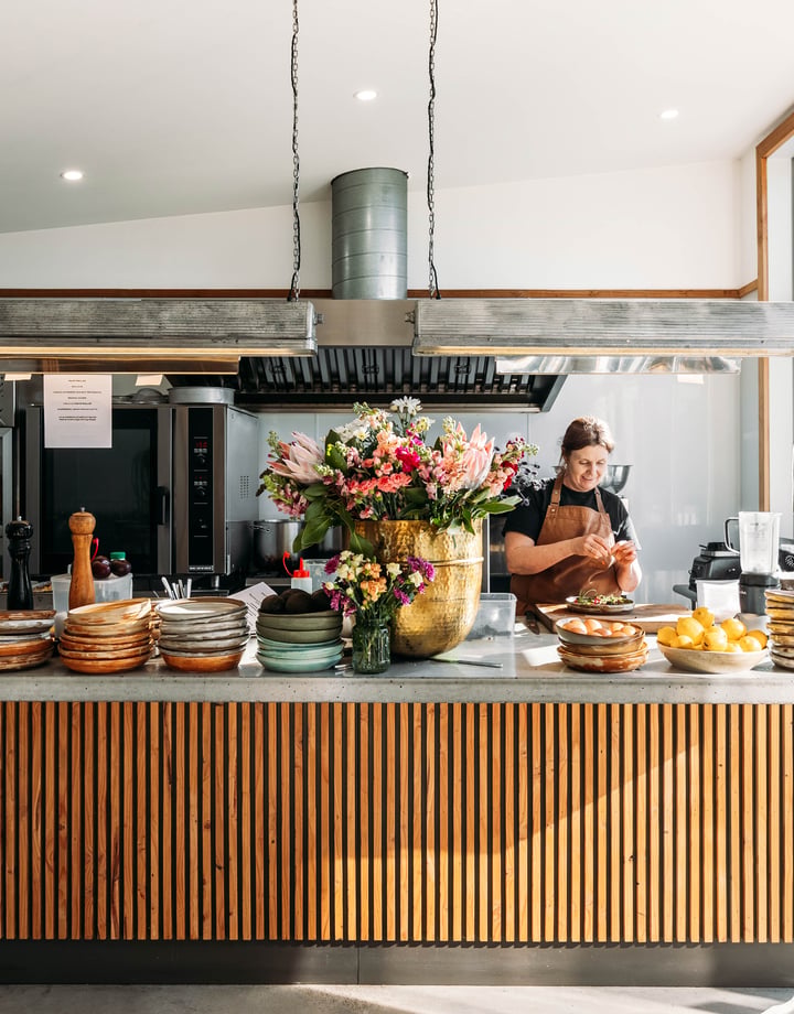 A woman working behind the cafe counter at Packing Shed.