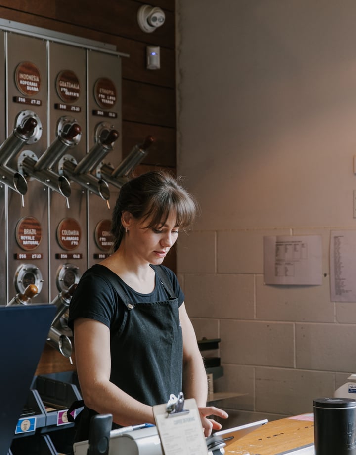 A woman working behind the counter at C4.