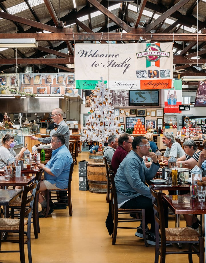 People dining at tables inside an Italian restaurant.