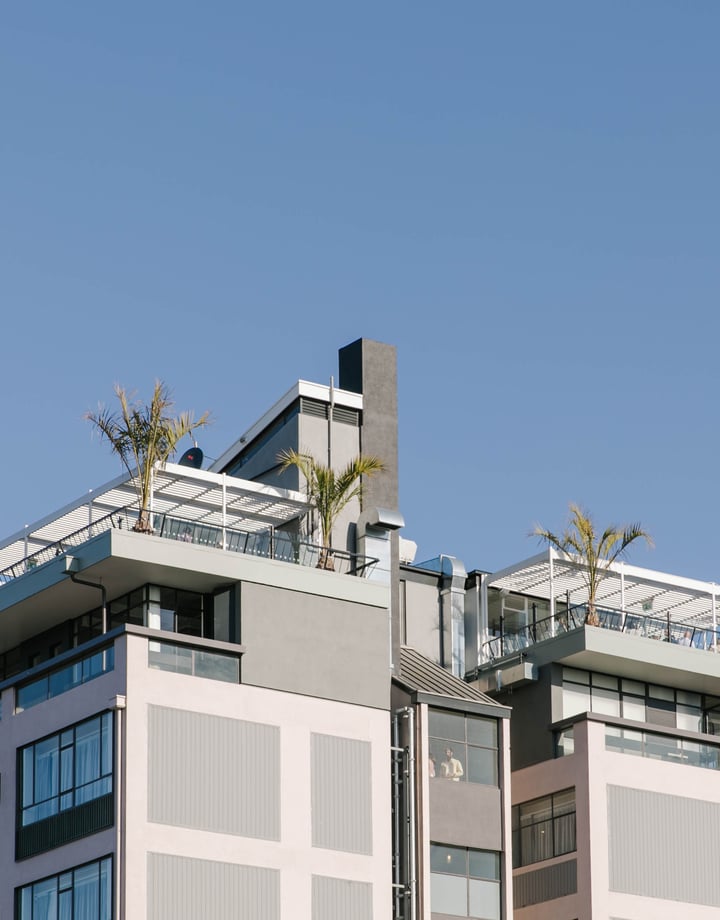 A view of the Pink Lady building looking up from the ground.