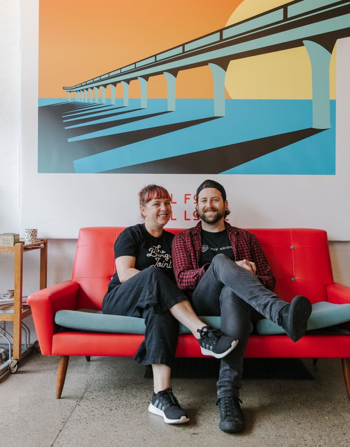 Sam and Caroline sitting on the couch at The Burger Joint, New Brighton.