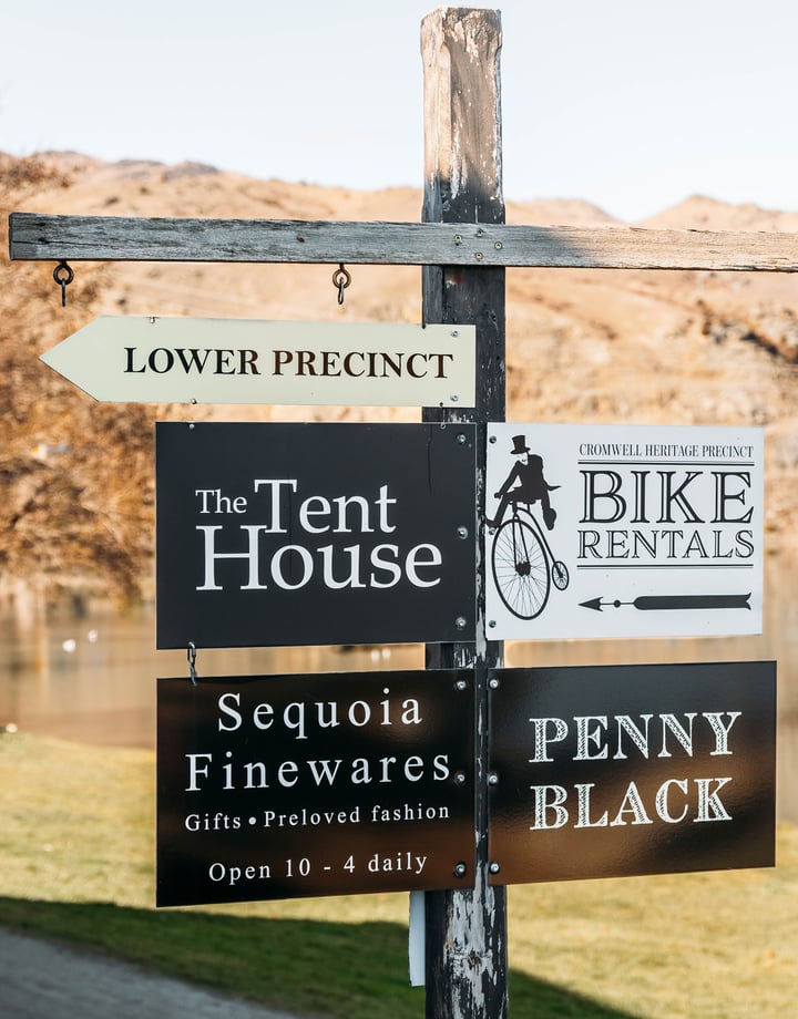 A lake view in Cromwell with signs in the forefront.