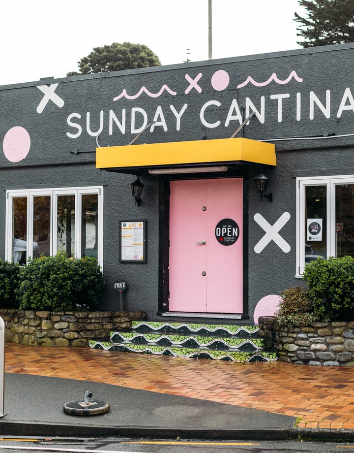 A colourfully decorated building that houses 'Sunday Cantina' cafe.