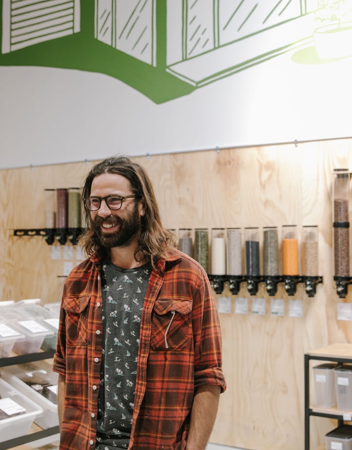 Close up of Jesse Herbert standing inside Freshlink Grocer.