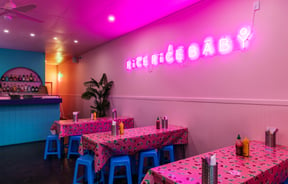 The bright pink and blue interior of Rice Rice Baby in Hamilton.