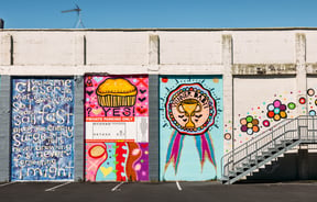 Colourful murals painted on a block wall.
