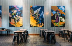 Three large works of art on wall at Brewtown in Upper Hutt.