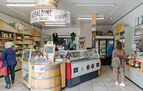 Customers browsing inside Geraldine Cheese Company store.
