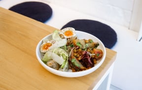 Bowl of fresh salad with a boiled egg on the table at Estelle Cafe in Christchurch