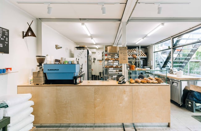 Interior view of the coffee counter and working bakery behind at Billow, New Plymouth.