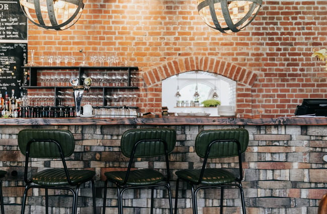 Brick wall and wine bar with pendant lighting at Cellar Door in Christchurch.