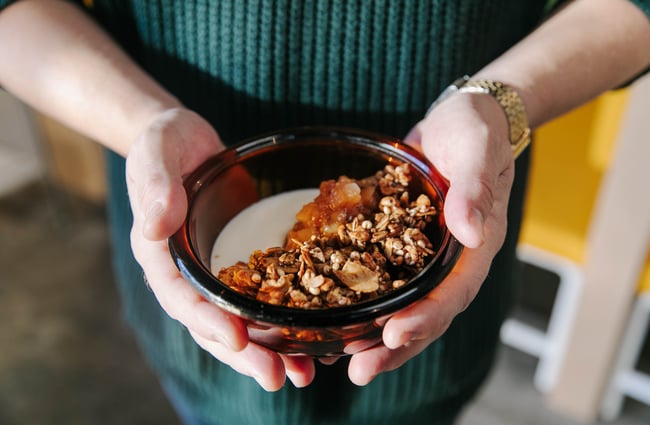 Holding a bowl of granola from Grizzly Baked Goods in the Christchurch CBD.
