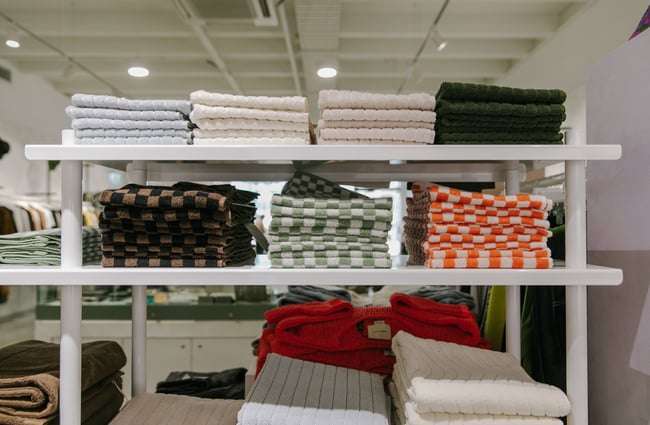 Close up of checked folded towels on the shelves.